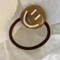 Brown acrylic hair tie featuring a white smile pattern on a marble texture bead detail - Smiley Face Style / Coffee