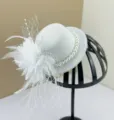 Elegant white vintage fascinator hat featuring pearls, feathers and a mesh veil detail - Vintage Mesh Fascinator Hat Clip / White