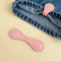 Pink magnetic pant cuff clip in faux leather used for shortening long trouser legs - Pink