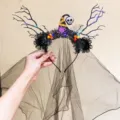 Detail of a glowing Halloween witch headband with black veil and skull decoration. - Glowing Skull Top Hat Veil (10)