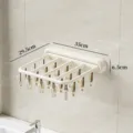 Foldable wall-mounted sock drying rack with multiple clips, white plastic laundry clothes hanger. - Wall-Mounted Drying Clips (20 Clips)