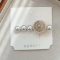 Elegant vintage hair clip featuring pearls and a rhinestone snowflake on a display card - Pink