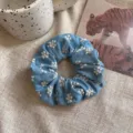Vintage blue denim scrunchie accessory with delicate white embroidered floral patterns - Light Blue Denim Floral Embroidery