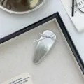 Premium silver PU leather hair clip featuring a delicate bow design and metallic finish - Bow PU Leather Hair Clip / Silver