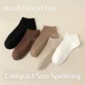 Macro view of five colors of ribbed low-cut cotton ankle socks for men in beige and black. - One Size / Mixed Colors