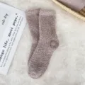 Detailed view of soft, cozy coral fleece sleep socks in dusty rose color on a plush white rug - Sizes 39-44 / Dark Khaki