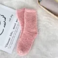 Close-up detail of soft pink coral fleece socks on a cozy white fluffy background - Sizes 39-44 / Jade Pink