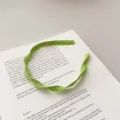 Sweet light green flat braided mesh fabric headband presented in French literary style - Flat Twist Braid / Green Spiral