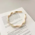 Elegant French style apricot braided mesh fabric headband on a vintage open art book - Flat Twist Braid / Light Yellow Spiral