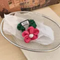 Vintage green fabric scrunchie featuring a large pink flower with a pearl accent - Rose Red