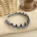 Light blue textured headband with black spikes and pearls for a high skull top look. - Blue small fragrance style rhinestone model