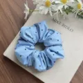Elegant light blue padded cotton scrunchie with black heart patterns for hair styling - Blue Heart