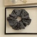 Large grey fabric scrunchie featuring elegant black heart patterns for hair styling - Heart Style / Gray