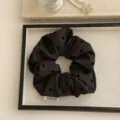 Elegant black fabric scrunchie with subtle heart pattern embroidery on a white tray - Heart Style / Black
