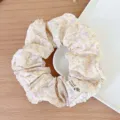 Elegant floral print scrunchie in cream and purple with a handmade fabric label tag - Girl Purple Floral