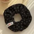 Korean style black floral scrunchie with ribbed fabric and a decorative ZOY label - Floral Pattern / Black