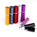 Detail shot of portable 10ml aluminum perfume atomizer spray bottle with glass liner. - Purple