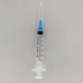 Transparent plastic perfume dispenser syringe tool with needle and clear measurement scale. - 5ml