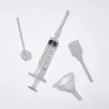 Detail view of 5ml perfume decanting syringe tool with funnel and straw accessories. - Four-Piece Set / Clear