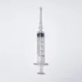Close-up detail of a 5ml clear plastic perfume dispenser syringe with volume scale markings. - 5ml / Clear