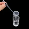 Close up view of transparent glass perfume bottle with plastic funnel and dropper tool. - Long Pipettes (1ml)