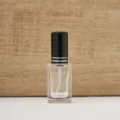 Detail shot of clear square 10ml glass perfume bottle with black cap and silver ring. - 10ML / Black