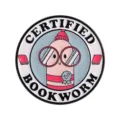 Round enamel pin featuring a cute pink worm character wearing glasses with Certified Bookworm text - Motivational Bookworm Style (UVXZ229)