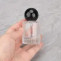Clear glass perfume bottle detail shot featuring a round black cap and portable spray nozzle. - Black Ball