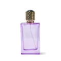 Detailed view of the purple glass perfume bottle with golden ornate cap and spray nozzle. - 50ML / Pink