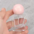 Close-up of square glass perfume bottle with pink round cap for travel sub-packaging. - 30ml / Pink