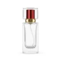 Detail view of empty clear glass perfume bottle with spray pump and elegant square cap. - Red