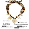 Leopard print silk scarf necklace with a large heart pendant and several gold charms - Helios Crown Pendant Necklace (XL32415)