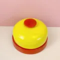 Detailed view of the bright yellow and red metal call bell, perfect for desk or pet training use. - Red Base Yellow