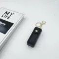Black leather lipstick case keychain with gold hardware, elegant mini pouch for daily use. - Black