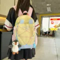 Großer gelb-blauer Schulrucksack für Schüler mit einem niedlichen Pinguin-Anhänger - L / Mit Anhänger / Gelb