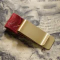 Vintage brass metal money clip and pen holder featuring a stylish red embossed leather loop. - Brass - Carved Red