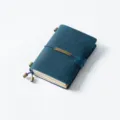 Vintage blue leather traveler notebook with brass charms and elastic band, perfect journal. - Passport Size / Crazy Horse Blueish