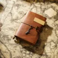 Vintage crazy horse leather travel notebook with metal clip and statue of liberty charm. - Passport Size / Brown