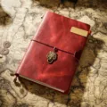 Vintage red leather traveler notebook with wolf charm and metal bookmark for daily journaling. - A5 Model / Burgundy