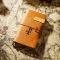 Vintage leather traveler's notebook with airplane charm, retro cowhide journal for daily writing. - Portable Size / Tan