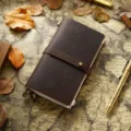 Carnet de voyage vintage en cuir de vachette avec fermeture a ceinture et stylo en laiton. - Taille portable / Café