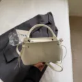 Elegant minimalist white bucket shoulder bag for women in commuter style with top handle - Single Bag / Off White