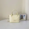 Elegante gelbe Polka-Dot-Eimertasche mit Tragegriff und Riemen - Einzelne Tasche / Gelb