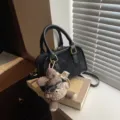 Chic black faux leather pillow handbag with cute plush bear charm for women - With Charm / Black