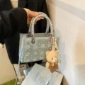 Light denim blue mini tote bag featuring woven silver handles and cute plush bear charm accessory - With Pendant / Silver