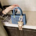 Small blue denim woven tote bag with sequins detail and a cute plush teddy bear charm - With Pendant / Dark Blue