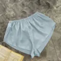 Elegant light blue satin loungewear shorts with elastic waist and silky smooth texture - S / Bottoms / Haze Blue