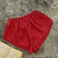 Red satin lounge shorts for women with elastic waist and shiny finish. - S / Bottoms / Red