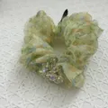 Close-up of floral organza hair scrunchie with iridescent crystal bead cluster detail. - Spring Green