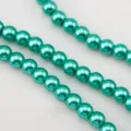 Close-up view of teal green high-luster round glass pearls for DIY necklace jewelry making - Lake Green / 1 Strand of Approx 110 Pcs (8mm)